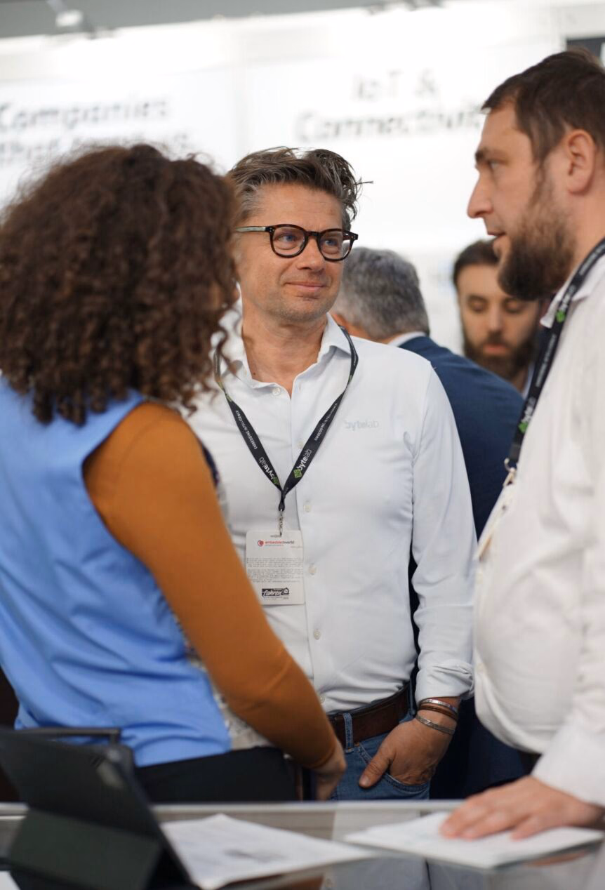 Berislav Sokač in conversation with two people on a conference floor